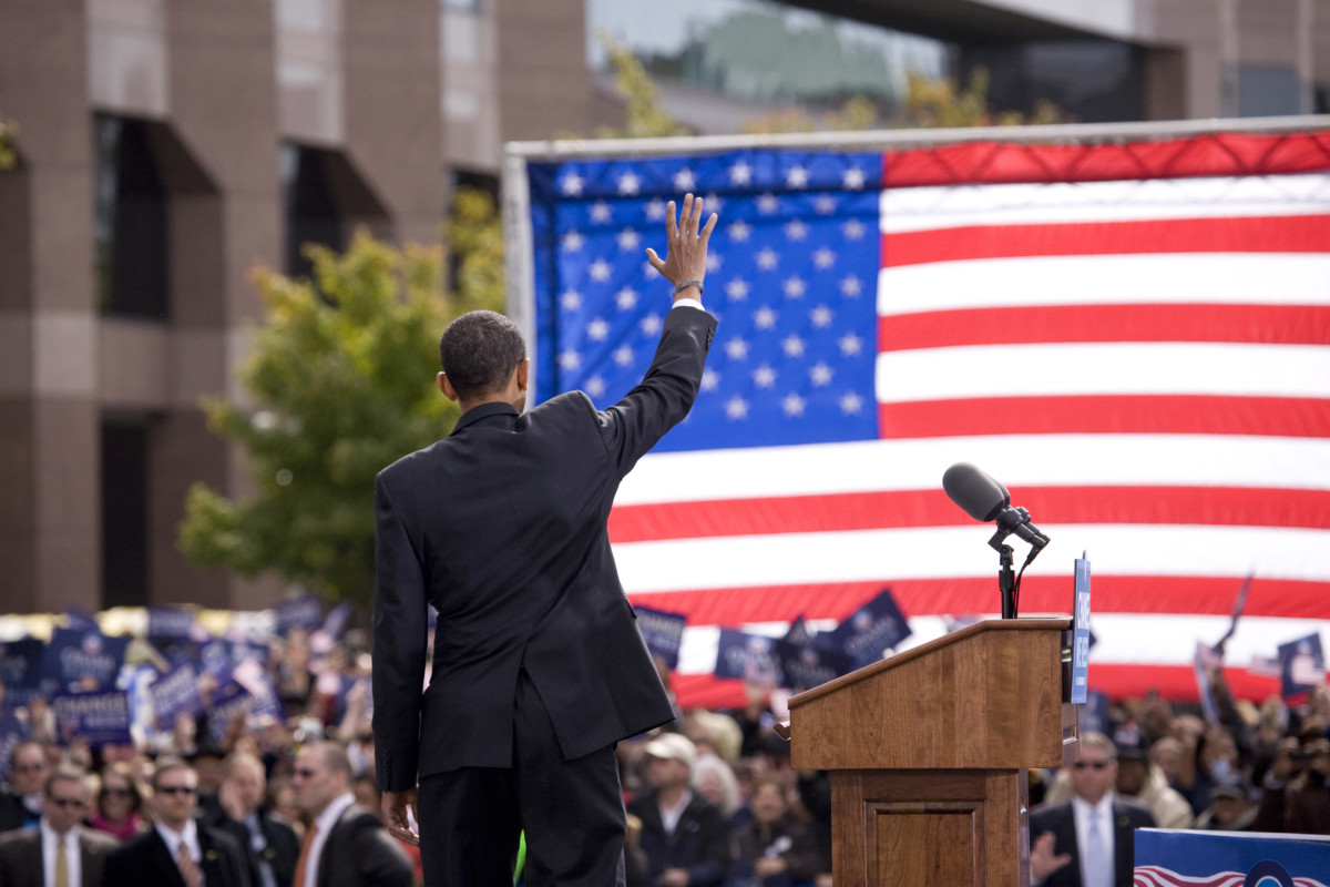 Presidential Candidate Barack Obama waves to crowd as he is framed against American Flag at early vote for change Presidential rally October 29, 2008 at Halifax Mall, Government Complex in Raleigh, NC