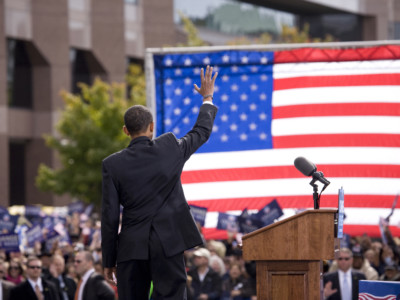 Presidential Candidate Barack Obama waves to crowd as he is framed against American Flag at early vote for change Presidential rally October 29, 2008 at Halifax Mall, Government Complex in Raleigh, NC