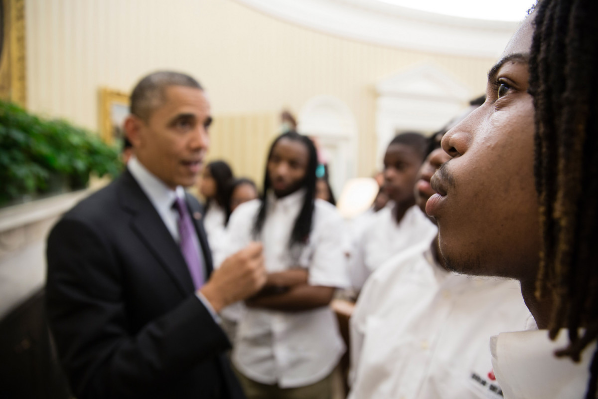 Students from William R. Harper High School in Chicago, Illinois, listen as President Barack Obama talks with them about the Emancipation Proclamation hanging in the Oval Office, June 5, 2013.