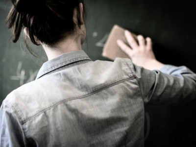 Teacher clears chalk board