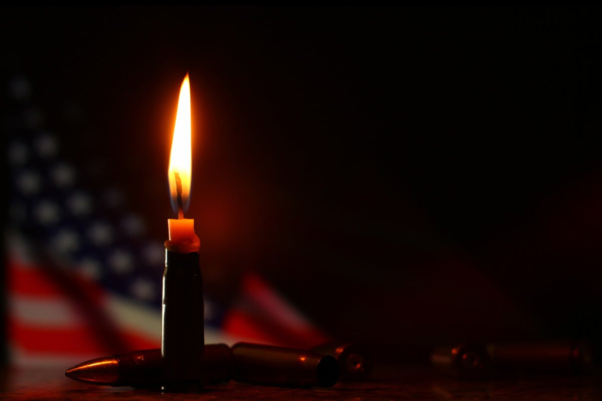 Candle and USA flag in the dark