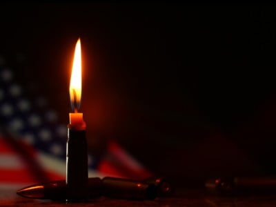 Candle and USA flag in the dark
