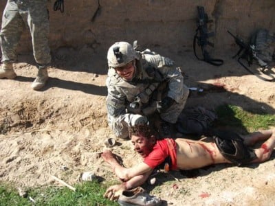 Cpl. Jeremy Morlock poses with the body of an unarmed Afghan boy named Gul Mudin in the village of La Mohammad Kalay. (Photo: US Army)
