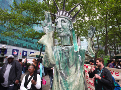 Occupy Wall Street members wrangle their own Statue of Liberty in Bryant Park before marching in honor of International Workers' Day on May 1, 2012, in New York City.