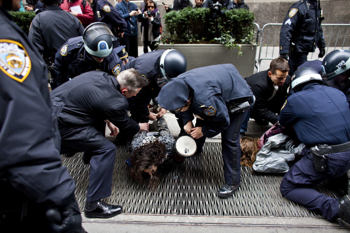 NYPD officers arrest two protestors with the Occupy Wall Street movement near Wall Street in Lower Manhattan in New York City, November 17, 2011.