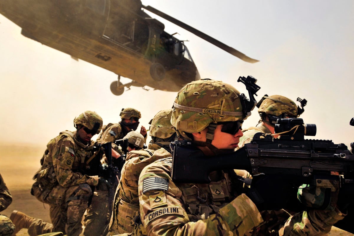 Pfc. Samuel Corsolini, 2nd Battalion, 25th Aviation Regiment, 25th Combat Aviation Brigade, pulls security with other Pathfinders as a UH-60 Black Hawk helicopter takes off after unloading his team and members of 2nd Afghan National Civil Order Patrol Special Weapons And Tactics Team in Kandahar province, Afghanistan, March 16.