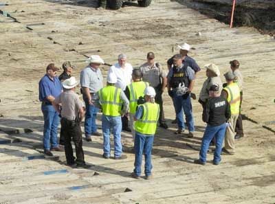 TransCanada supervisors huddle with local off-duty police officers and the private security they hired during a blockade action on Monday, October 15, when more than 50 activists stormed the pipeline easement in an attempt to re-supply blockaders occupying a tree village in Winnsboro, Texas, to halt construction on the southern leg of the Keystone XL pipeline.