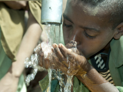 Child drinking water from fountain