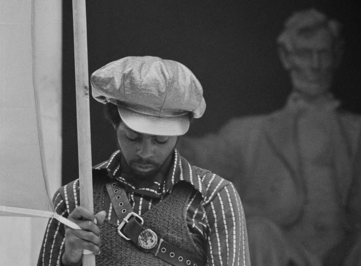 A member of the Black Panther Party holds a banner for the Revolutionary People's Constitutional Convention in front of the Lincoln Memorial, June 19, 1970.