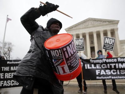 Activists stage an anti-Trump protest in front of the US Supreme Court January 23, 2017, in Washington, DC. The group, Refuse Fascism, called for a "must stop business as usual this week" to "stop the Trump/Pence regime."