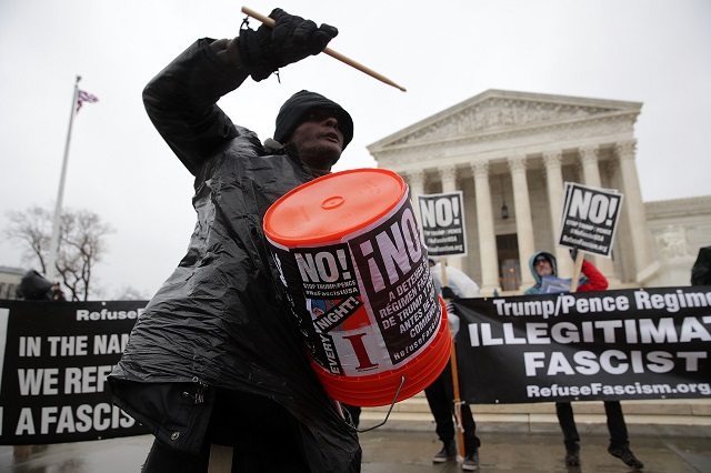 Activists stage an anti-Trump protest in front of the US Supreme Court January 23, 2017, in Washington, DC. The group, Refuse Fascism, called for a "must stop business as usual this week" to "stop the Trump/Pence regime."