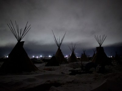 Giant flood lights set up by a pipeline company and law enforcement illuminate a cloudy winter night at the Oceti Sakowin camp just outside of the Lakota Sioux reservation of Standing Rock, North Dakota, on December 1, 2016.