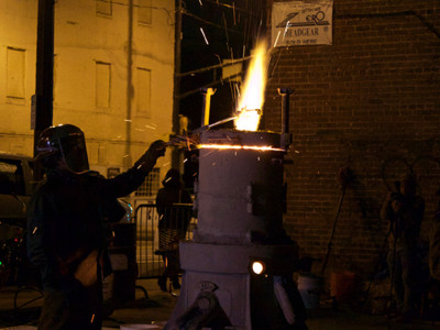 A volunteer with Lead to Life melts down a weapon to create a shovel with the gunmetal.