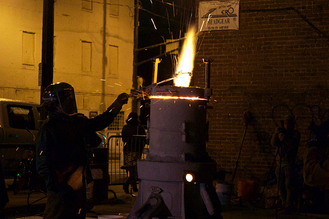 A volunteer with Lead to Life melts down a weapon to create a shovel with the gunmetal.