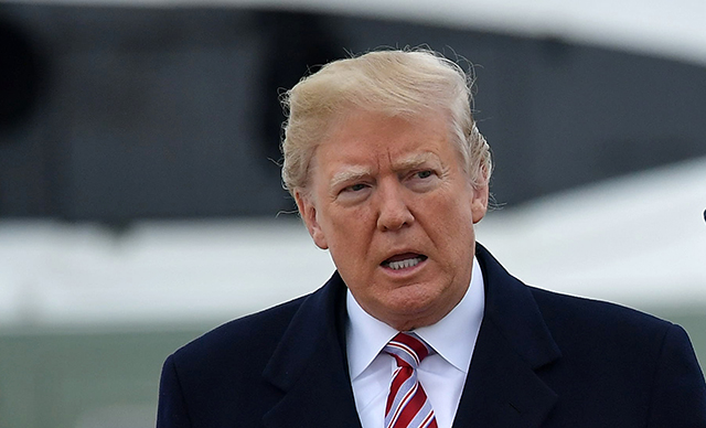 Donald Trump makes his way to board Air Force One at Andrews Air Force Base in Maryland, on April 16, 2018. Trump is traveling to Hialeah, Florida, for a roundtable discussion on tax reform.