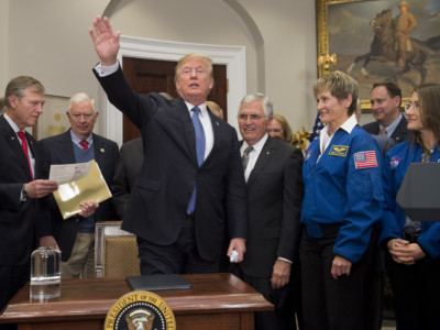Donald Trump waves alongside former US Senator and Apollo 17 astronaut Jack Schmitt and NASA astronaut Peggy Whitson after a signing ceremony for Space Policy Directive 1 in Washington, DC, on December 11, 2017.