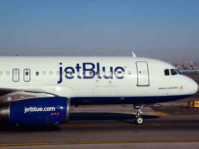 A JetBlue passenger jet (Embraer 190) taxis at LaGuardia Airport in New York, New York.