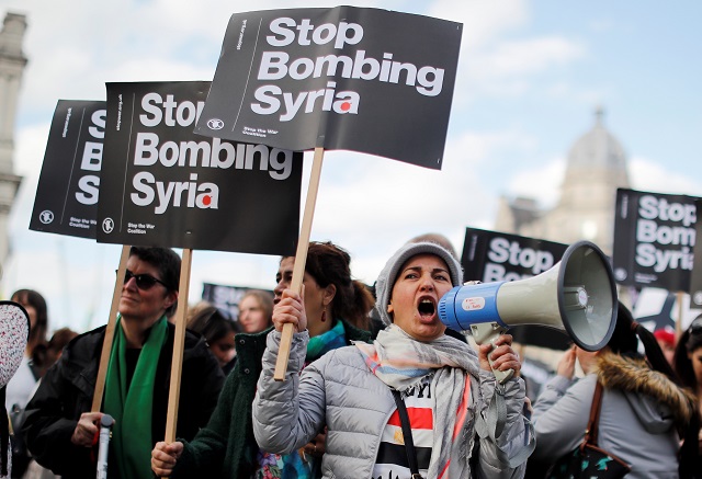 Protesters demonstrate against the UK's military involvement as the US and its allies conduct airstrikes against Syria.