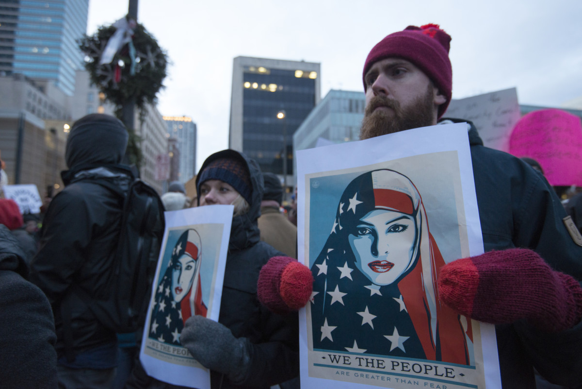 Protesters display signs during a march against Donald Trump's proposed Muslim ban on January 31, 2017, in Minneapolis, Minnesota.