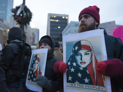 Protesters display signs during a march against Donald Trump's proposed Muslim ban on January 31, 2017, in Minneapolis, Minnesota.