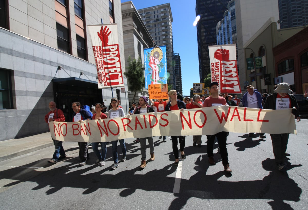 Activists display a sign during the International Workers' Day march on May 1, 2017, in San Francisco, California. (Photo: Peg Hunter)