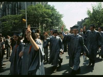 Columbia University seniors in cap and gown walk out on their graduation excercises at the Cathedral of St. John the Divine to join some 1,500 student and parent demonstrators on the streets outside on June 4, 1968, in New York City.