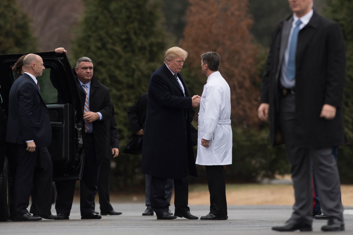 President Donald Trump shakes hands with White House Physician Rear Admiral Ronny Jackson, following his annual physical at Walter Reed National Military Medical Center in Bethesda, Maryland, January 12, 2018.