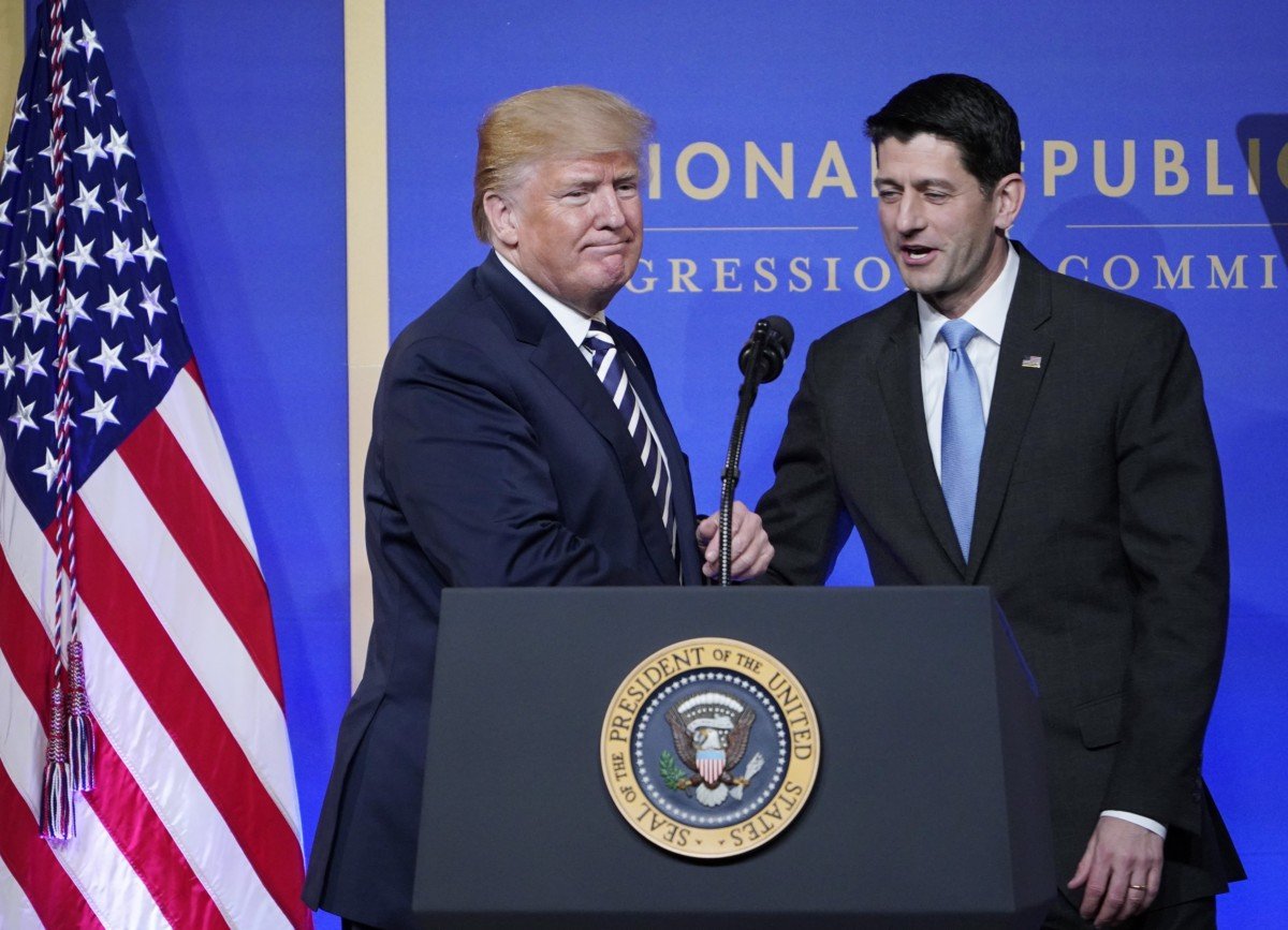 House Speaker Paul Ryan greets Donald Trump as he arrives on stage to speak at the National Republican Congressional Committee March Dinner at the National Building Museum on March 20, 2018, in Washington, DC.