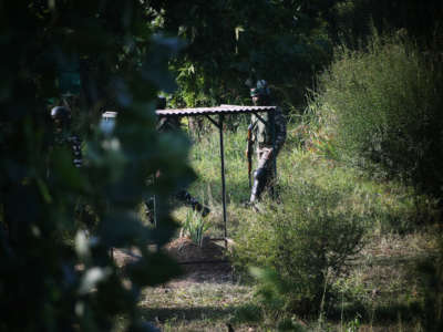 Paramilitary forces patrol the grave of Syed Ali Shah Geelani.