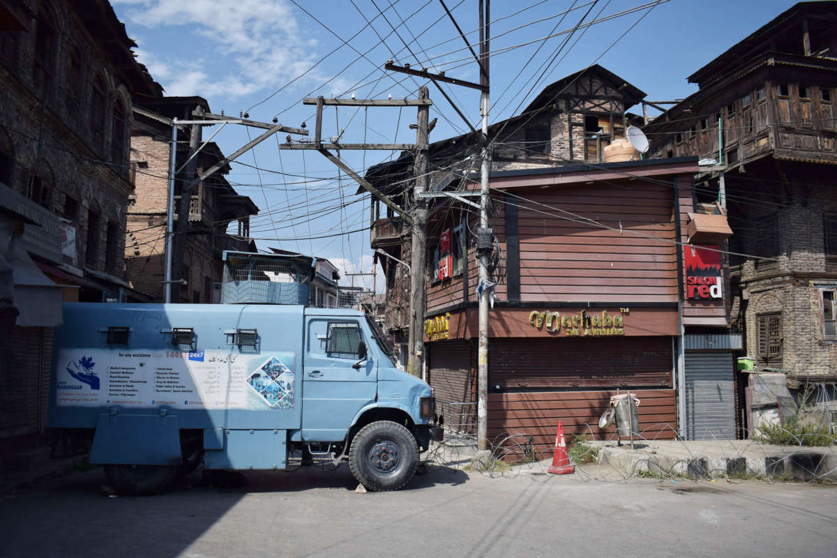 Neighborhoods in downtown Srinagar are barricaded by a police vehicle.