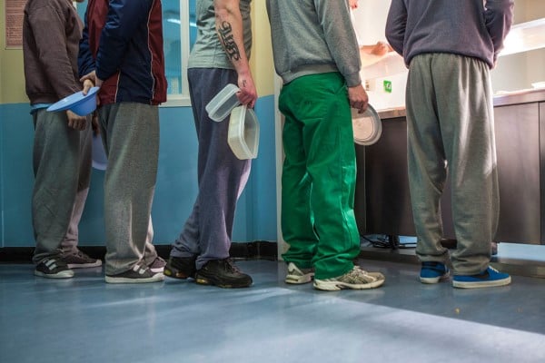 Prisoners line up at the canteen for lunch.