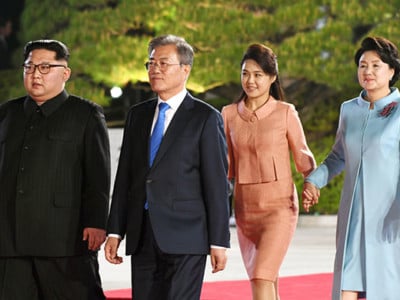North Korea's leader Kim Jong Un and his wife Ri Sol Ju walk with South Korea's President Moon Jae-in and his wife Kim Jung-sook during a farewell ceremony at the end of their historic summit at the truce village of Panmunjom on April 27, 2018.