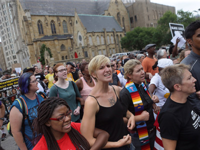 Protesters and clergy members march on August 10, 2015, in St. Louis, Missouri, as part of a Moral Monday demonstration.