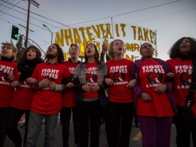 Striking McDonald's restaurant employees lock arms in an intersection before being arrested, after walking off the job to demand to demand a $15 per hour wage and union rights during nationwide 'Fight for $15 Day of Disruption' protests on November 29, 2016 in Los Angeles, California.