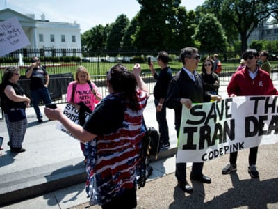 Supporters of President Donald Trump argue with people protesting outside the White House as President Trump announces the United State's withdrawal from the Iran nuclear deal, May 8, 2018 in Washington, DC.