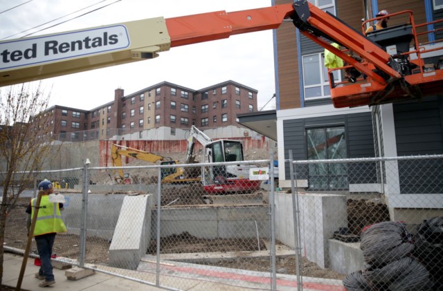 Construction takes place at the public housing complex in East Boston's Orient Heights on April 13, 2018.