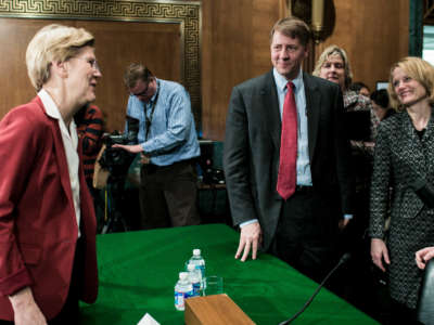 Sen. Elizabeth Warren. left, speaks with Richard Cordray, center, nominee for director of the Consumer Financial Protection Bureau, after a confirmation hearing in the Senate Committee on Banking, Housing and Urban Affairs on March 12, 2013, in Washington, D.C.