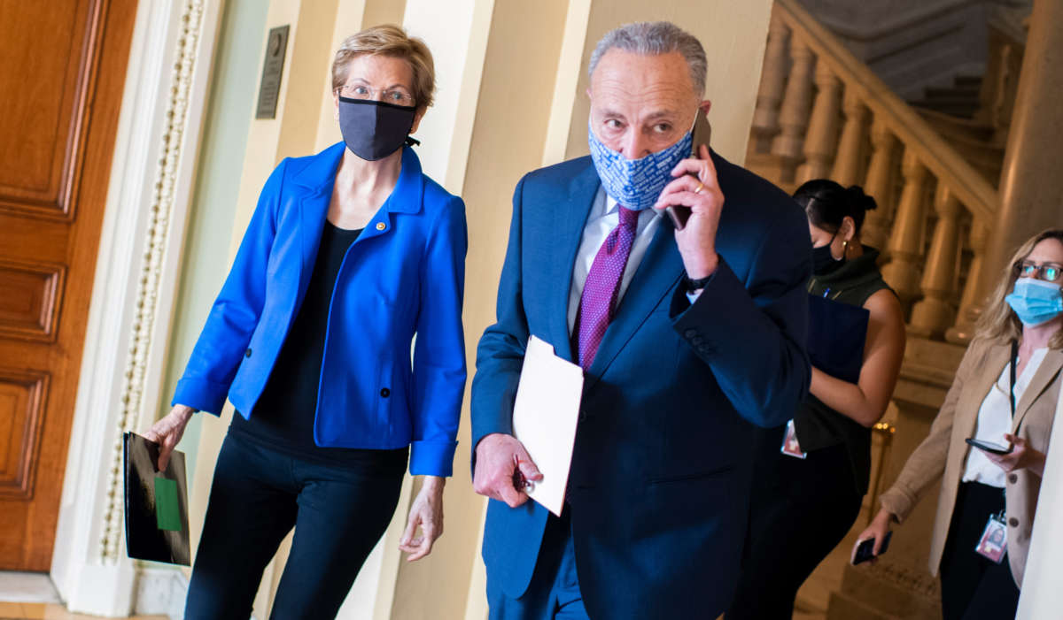 Senate Minority Leader Charles Schumer and Sen. Elizabeth Warren make their way to a news conference on COVID-19 relief in the Capitol on October 20, 2020.