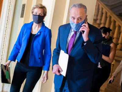 Senate Minority Leader Charles Schumer and Sen. Elizabeth Warren make their way to a news conference on COVID-19 relief in the Capitol on October 20, 2020.