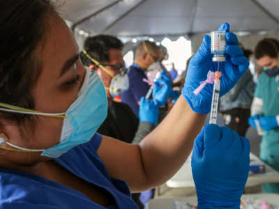 Jacquelyn Zaval, RN, prepares Moderna mRNA-1273 vaccine at a super site COVID-19 vaccination event held by San Bernardino County health at Auto Club Speedway on February 2, 2021, in Fontana, California.