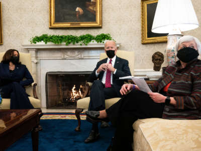 (L-R) Vice President Kamala Harris and President Joe Biden meet with Treasury Secretary Janet Yellen in the Oval Office of the White House on January 29, 2021, in Washington, D.C.