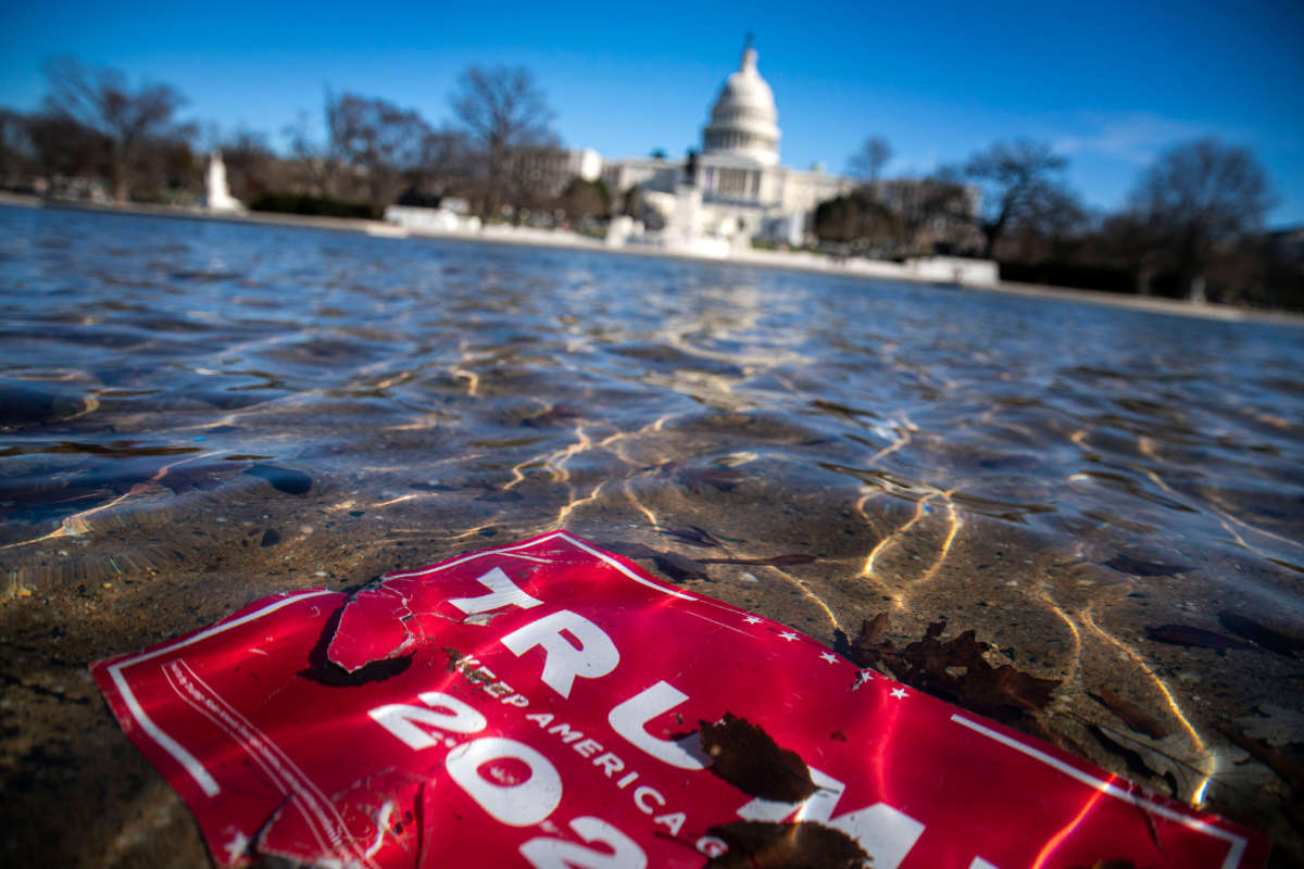 A campaign sign for President Donald Trump lies beneath water in the Capitol Reflecting Pool on Capitol Hill on January 9, 2021, in Washington, D.C.