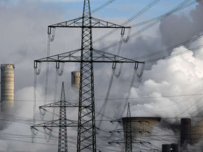 Electricity pylons are seen in front of the cooling towers of a coal-fired power station in Weisweiler, western Germany, on January 26, 2021.