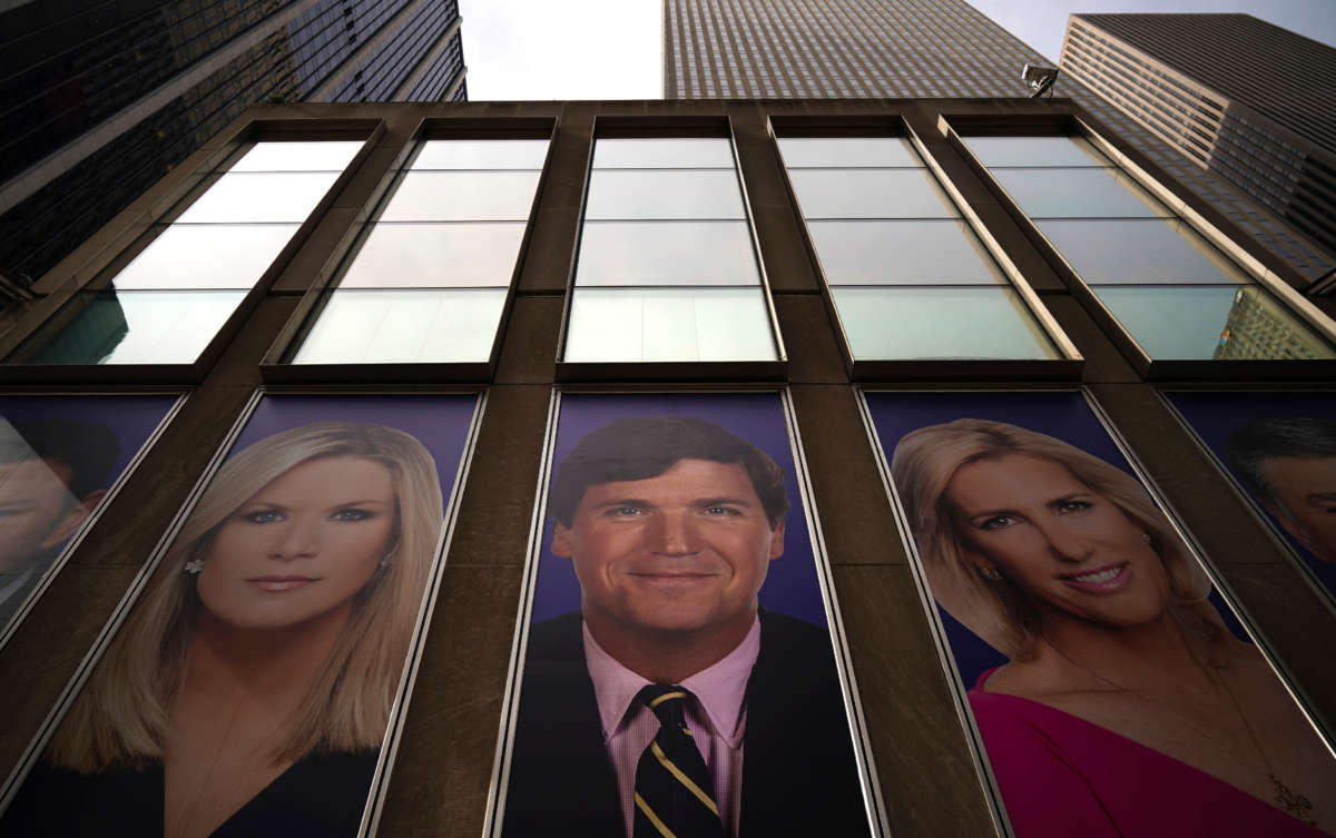 Advertisements featuring Fox News personalities, including Tucker Carlson (C), adorn the front of the News Corporation building, March 13, 2019, in New York City.