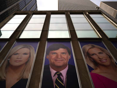 Advertisements featuring Fox News personalities, including Tucker Carlson (C), adorn the front of the News Corporation building, March 13, 2019, in New York City.