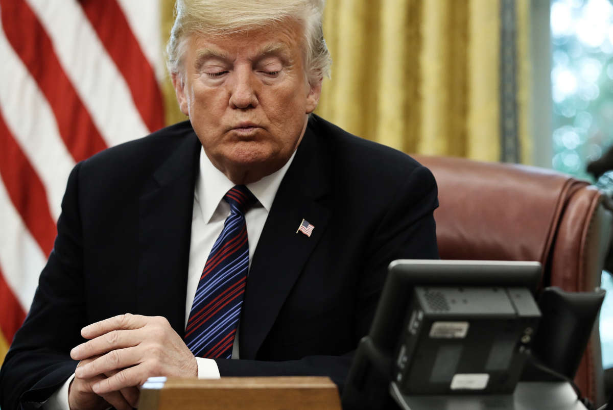 President Trump speaks on the telephone via speakerphone in the Oval Office of the White House on August 27, 2018, in Washington, D.C.