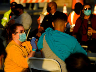 A nurse administers a dose of the Moderna COVID-19 vaccine at a vaccination site at Dignity Health Sports Park on February 16, 2021, in Carson, California.