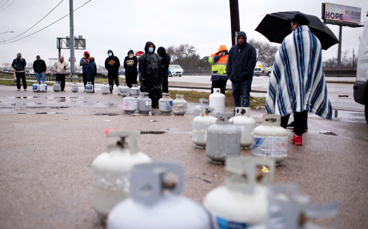 Propane tanks are placed in a line as people wait for the power to turn on to fill their tanks in Houston, Texas on February 17, 2021.