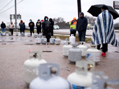 Propane tanks are placed in a line as people wait for the power to turn on to fill their tanks in Houston, Texas on February 17, 2021.