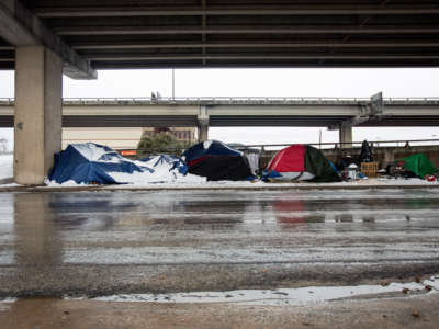 Homeless camps sit along the I-35 frontage road in Austin, Texas, on February 17, 2021.